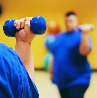 Close Up of an Overweight Man Weight Training in a Gym
