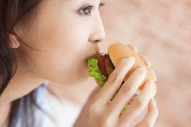 Young woman eating a hamburger