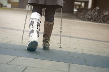 closeup of woman walking with crutches