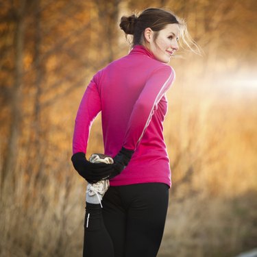 Young woman stretching before her run