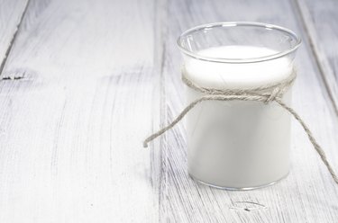 glass of milk on white wooden table