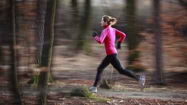 Young woman running outdoors in a city park