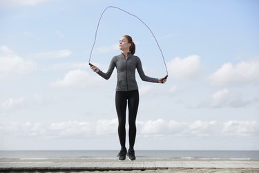 Healthy young woman with jump rope