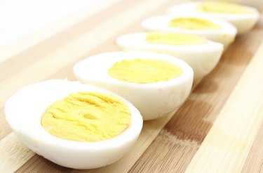 Hard-boiled eggs left out on cutting board