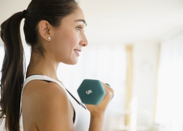 Caucasian woman lifting weights