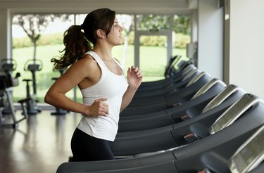 Young woman running on treadmill