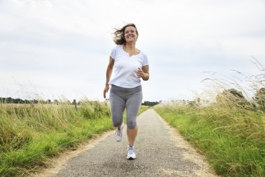 active mature woman jogging outdoors