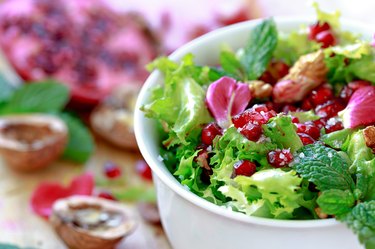 Curly endive salad with pomegranate, nuts, rose petals...