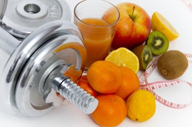 Fitness equipment and healthy food, apple, nectarines, kiwi, lem