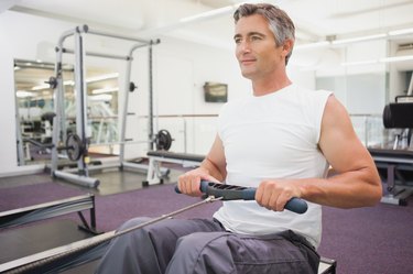 Fit man working out on rowing machine