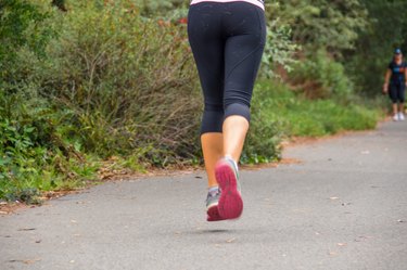 Young woman running on trail