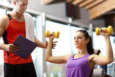 Young woman lifting weights