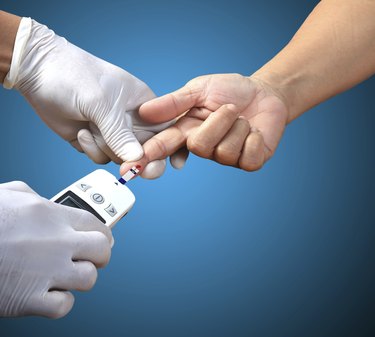 Doctor testing blood sugar value is measured on a finger