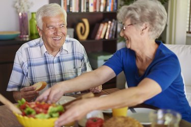 Senior couple eating delicious breakfast