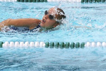 Close-up shot of a person swimming in a lap pool, as a form of cardio exercise