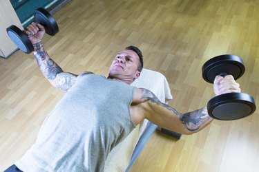 man making dumbbell fly - workout routine