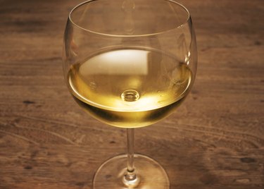 Glass of white wine on wood table