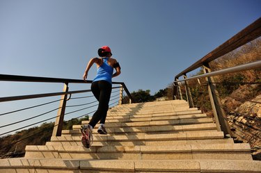 healthy lifestyle sports woman running up on stone stairs