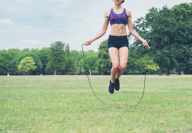 Young woman skipping in the park