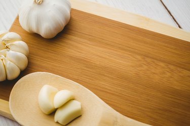 Garlic cloves and bulb on chopping board