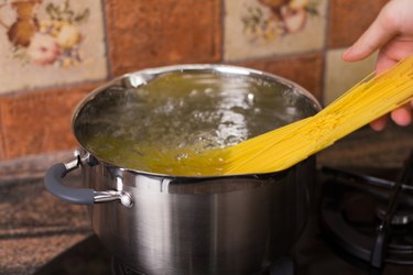 Put spaghetti pasta into boiling water