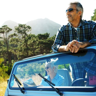 mature couple in a jeep in the woods