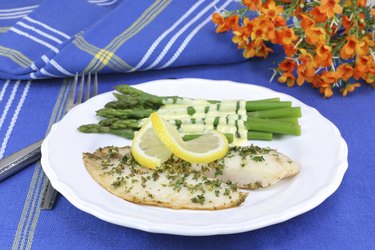 Healthy, fresh tilapia fillets with asparagus and Hollandaise sa