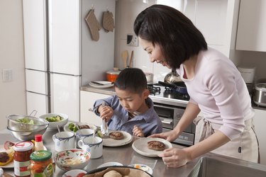 Boy Arranging Dishes on Plate