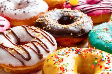 donuts, a sugary food, in multicolored glaze close-up