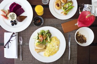 Fruit, eggs, cereal and pastry breakfast.