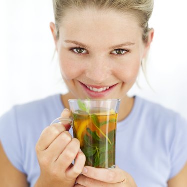Close-up of a woman holding a cup of herbal tea