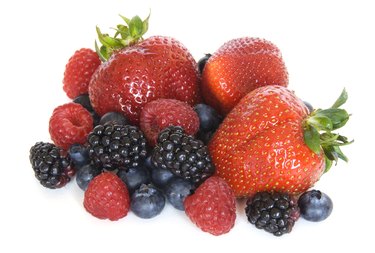Mixed berries - strawberries, raspberries, blackberries and blueberries on white
