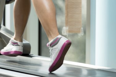 Fitness Woman Running On Treadmill