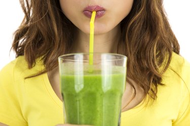 Woman drinking green smoothie