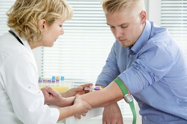 Nurse taking blood sample