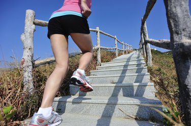 woman running up on mountain stairs