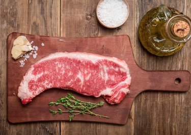 Raw beef meat Ribeye Steak with herbs and spices