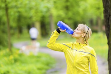 Female runner drinking water