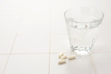Capsule and cup of water