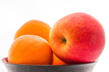 Apple with orange in the bowl.