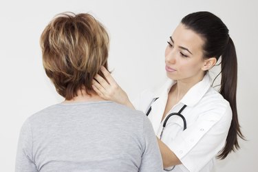 Young female doctor examining her patient