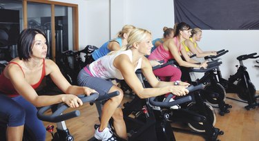 Beautiful women doing exercise in a spinning class at gym