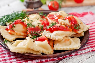 Delicious ravioli with tomato sauce and dill