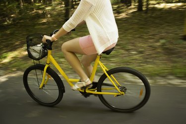 Motion blur.Riding yellow bicycle on the forest road.