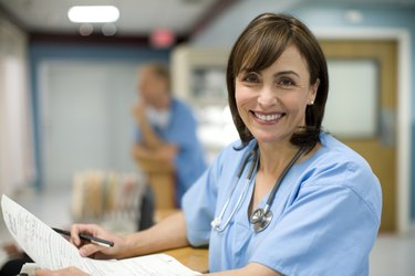 Female doctor holding medical records, smiling, portrait