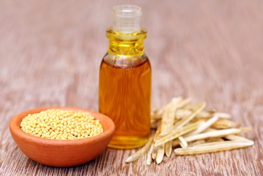 Golden Mustard with empty pods and oil in a bottle
