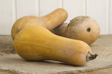 butternut pumpkins lying on a kitchen table