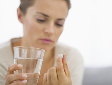 closeup on young housewife eating pills