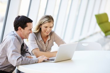 Business people Having Meeting Around Table In Modern Office