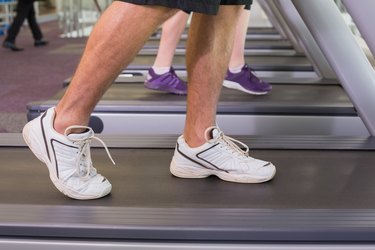 Man and woman walking on treadmills